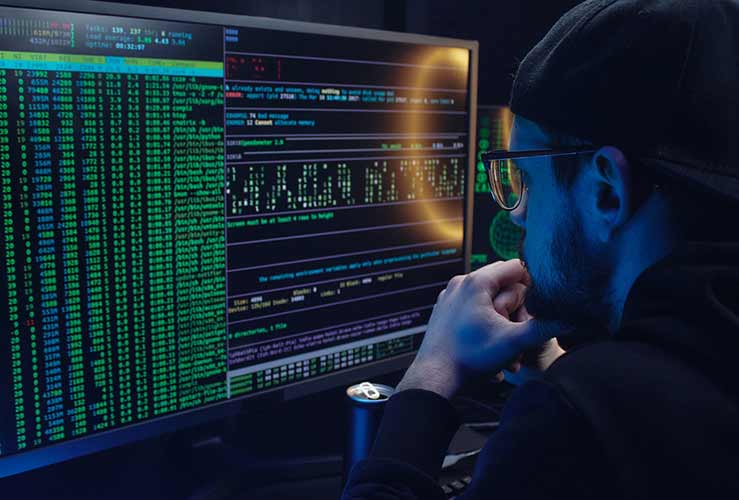 Engineer looking at code on computer screen