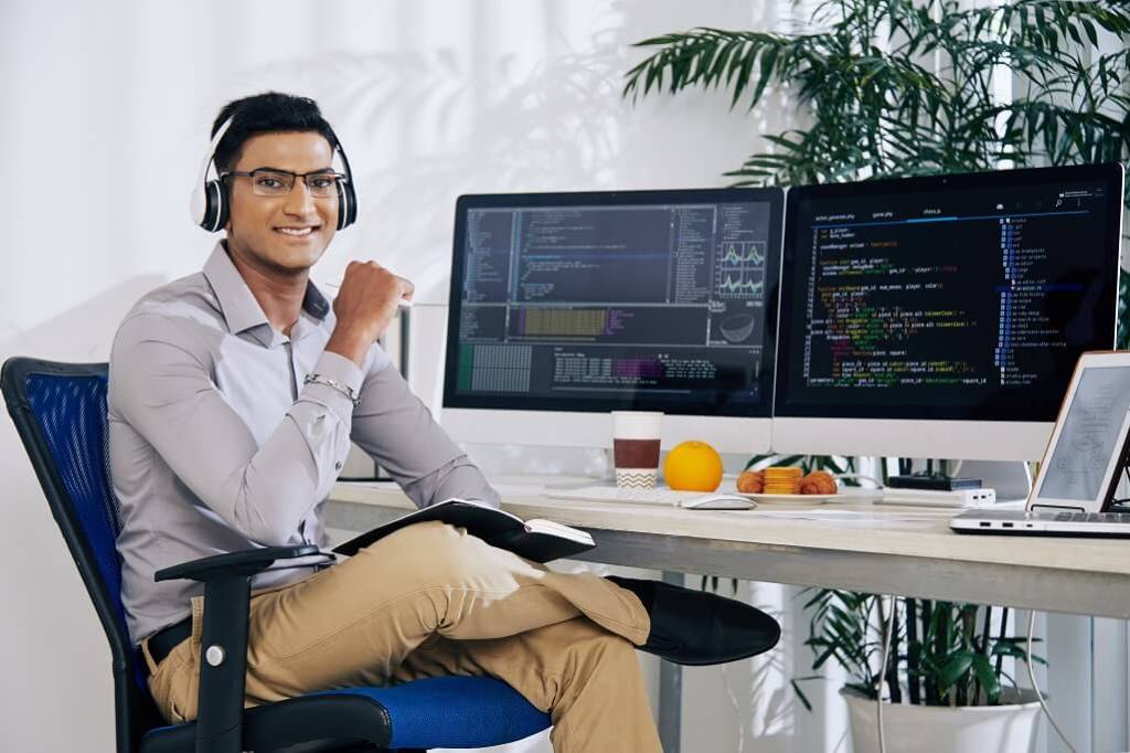A happy web developer at his workstation